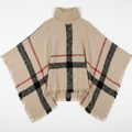 Cream plaid turtleneck poncho sweater with black and red stripes on white background