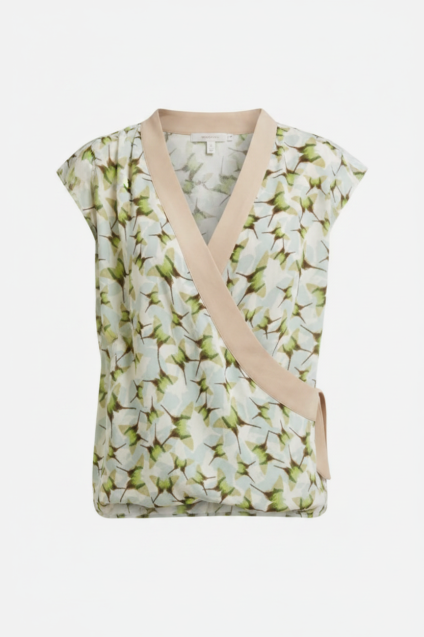 Cabi Butterfly green floral faux wrap top with nude panel on white background